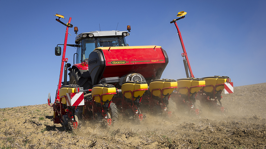 A red and yellow Väderstad Tempo highspeed planter in the field