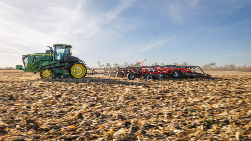 Wil-Rich 483 Chisel Pro in the field, pulled by a green tractor