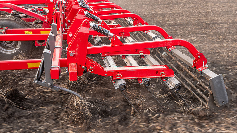 Detail photo of levelling attachments on the Wil-Rich QX2 field cultivator working on a field